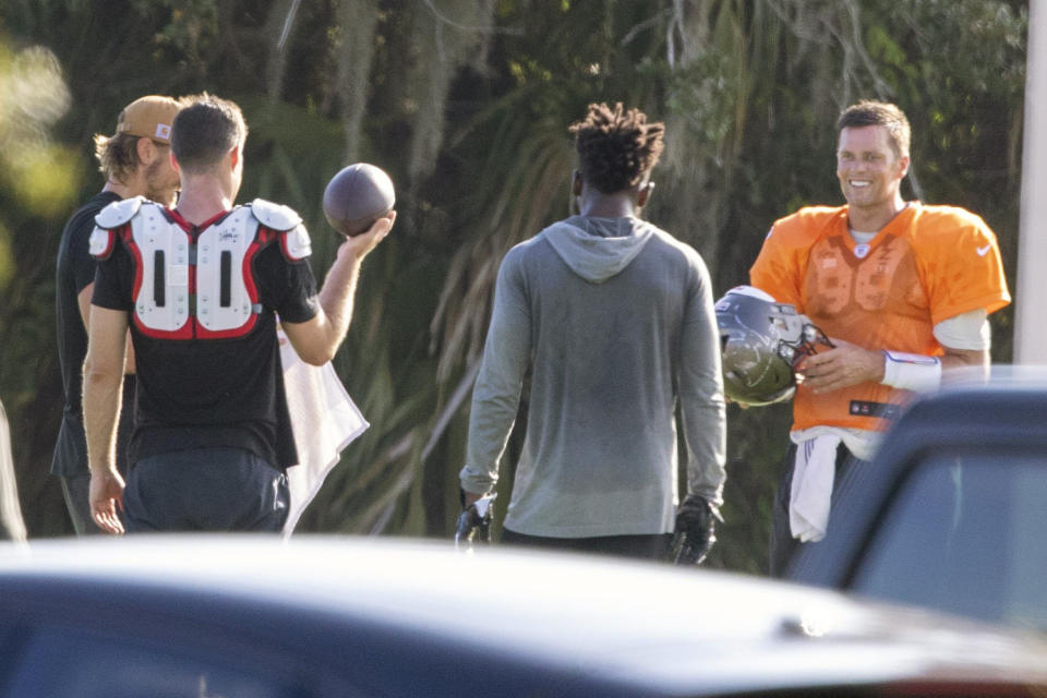 FILE - In this June 23, 2020, file photo, Tampa Bay Buccaneers NFL football quarterback Tom Brady, far right, is seen along with other players during a private workout at Berkeley Preparatory School in Tampa, Fla. Brady is looking for a big bounce-back this season. (Chris Urso/Tampa Bay Times via AP, File)