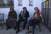 Palestinian mourners sit under posters showing Ammar Adili, 22, who was shot and killed by an Israeli border police officer on Friday, while receiving condolences at his home village of Osreen, south of the West Bank city of Nablus, Saturday, Dec. 3, 2022. Palestinians pushed back Saturday against Israeli police claims that Ammar Adili had attacked Israelis, including a border policeman, in the area and that he was shot in self-defense. They said the officer killed Adili without cause, and that Palestinian medics were kept from trying to save him as he lay gravely wounded on the side of a busy throughfare in the occupied West Bank town of Hawara.(AP Photo/Nasser Nasser)