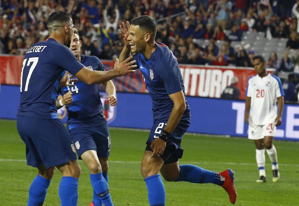 United States forward Christian Ramirez, middle, celebrates his goal with midfielder Sebastian Lletget (17) and midfielder Paul Arriola (14) as Panama midfielder Rolando Botello (20) pauses on the field during the second half of a men's international friendly soccer match Sunday, Jan. 27, 2019, in Phoenix. The United States defeated Panama 3-0. (AP Photo/Ross D. Franklin)