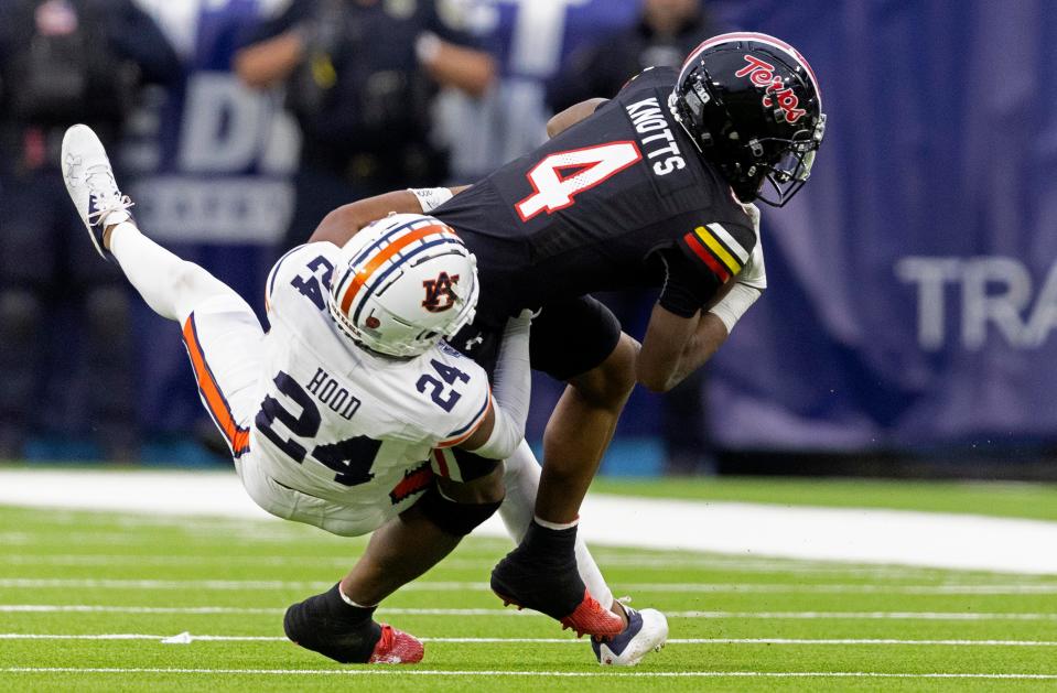 Dec 30, 2023; Nashville, Tennessee, United States; Maryland wide receiver Shaleak Knotts (4) is tackled by Auburn cornerback Colton Hood (24) during the TransPerfect Music City Bowl at Nissan Stadium. Mandatory Credit: Wade Payne-The Tennessean