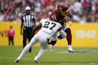 Washington Football Team running back Antonio Gibson (24) rushes the ball against New Orleans Saints safety Malcolm Jenkins in the first half of an NFL football game, Sunday, Oct. 10, 2021, in Landover, Md. (AP Photo/Alex Brandon)