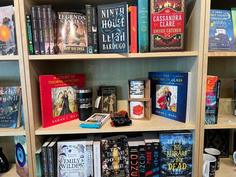 At Bookish, there are shelves stocked with a variety of books. Each bookshelf is divided into sections featuring genres, including memoirs, nature, fantasy, romance, and mystery.