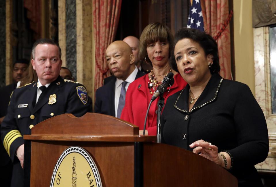 Attorney General Loretta Lynch, right, speaks during a joint news conference in Baltimore, Thursday, Jan. 12, 2017, to announce the Baltimore Police Department's commitment to a sweeping overhaul of its practices under a court-enforceable agreement with the federal government. Standing behind Lynch are Baltimore Police Department Commissioner Kevin Davis, from left, Rep. Elijah Cummings, D-Md., and Baltimore Mayor Catherine Pugh. (AP Photo/Patrick Semansky)