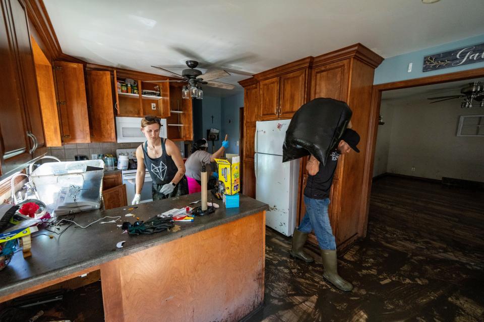 Residents and volunteers clean out Kellie Van Beek's home as the water recedes in Rock Valley, Monday, June 24, 2024.