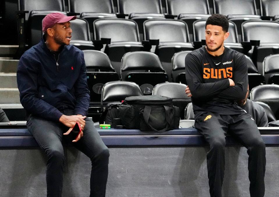 Phoenix Suns general manager James Jones talks to guard Devin Booker during a Friday practice in Denver on April 28, 2023, as the team prepares for the Western Conference Semifinals against the Denver Nuggets at Ball Arena.