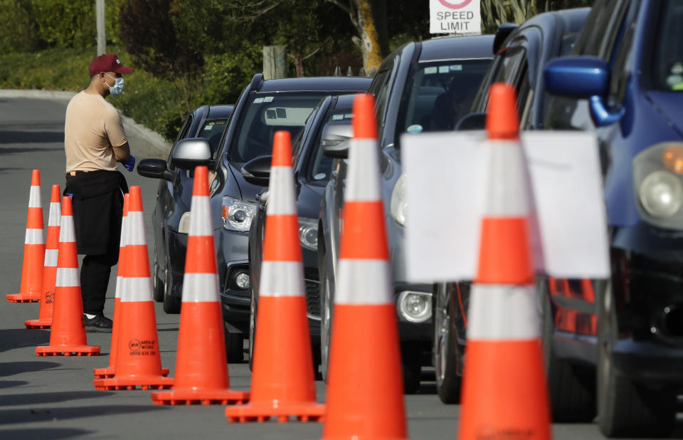 Motorists wait to take a COVID-19 test at a drive through community based assessment centre in Christchurch, New Zealand, Thursday, Aug. 13, 2020. Health authorities in New Zealand are scrambling to trace the source of a new outbreak of the coronavirus as the nation's largest city, Auckland, goes back into lockdown. (AP Photo/Mark Baker)