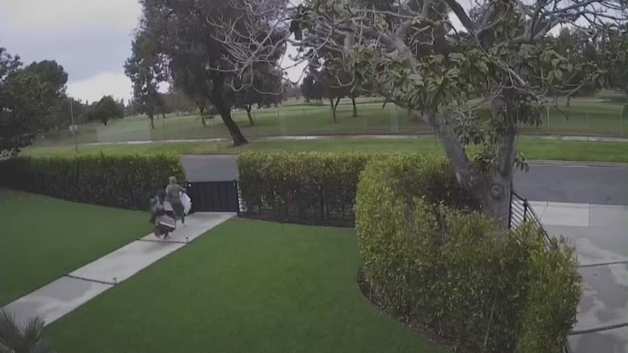 Security footage shows the two suspects fleeing the home through the front gate after stealing cash, jewelry, and a safe from the property. The victim spoke with KTLA on April 27, 2024. (KTLA)