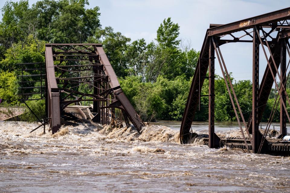 Flood water on the Big Sioux River flows over a collapsed BNSF rail bridge between between North Sioux City South Dakota and Sioux City, Monday, June 24, 2024.