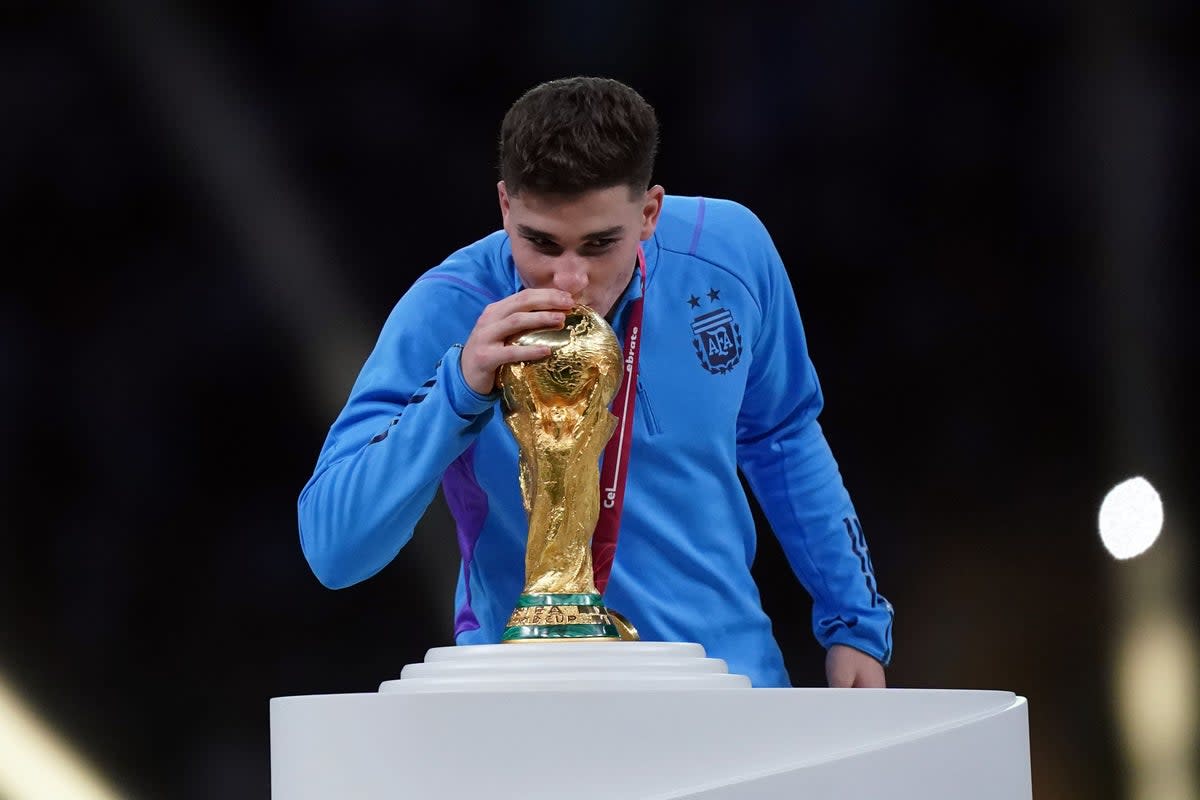 Julian Alvarez kisses the World Cup trophy (Mike Egerton/PA) (PA Wire)