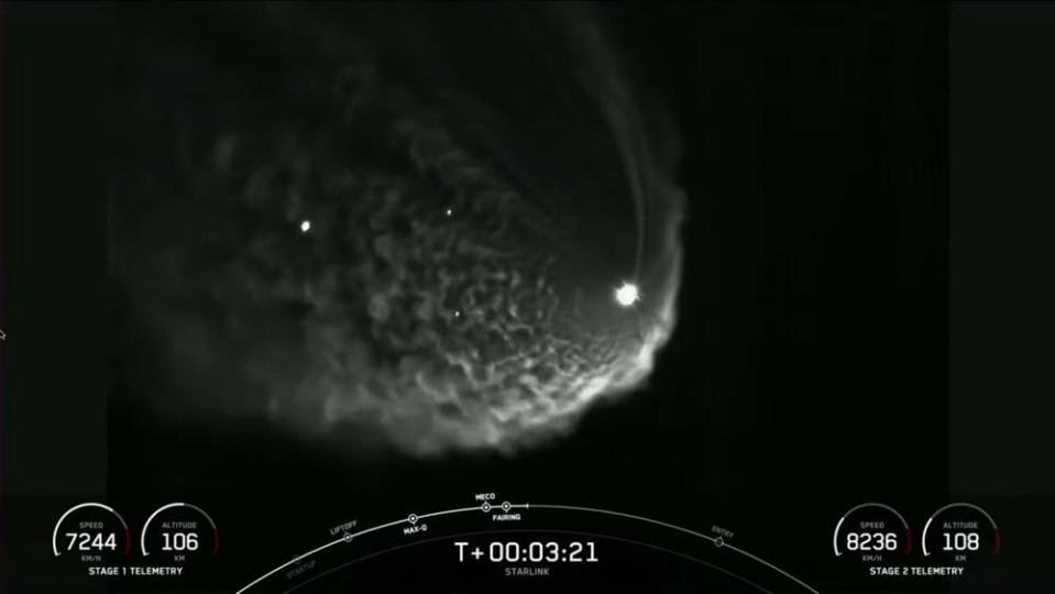 The exhaust plume of the Falcon 9's second stage engine expands in the low-pressure environment of the extreme upper atmosphere, creating a ghostly cloud. The rocket's first stage can be seen at left, along with the two halves of the rocket's discarded nose cone fairing. / Credit: SpaceX webcast