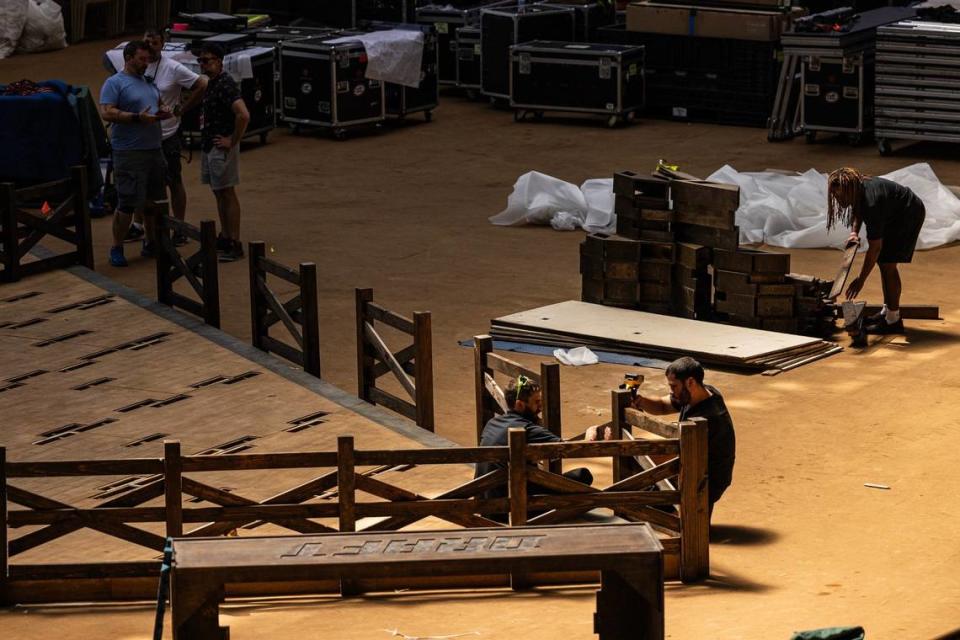 Workers construct the platform and stage area for the 2024 MLB Draft at the Cowtown Coliseum in the Fort Worth Stockyards on Thursday.