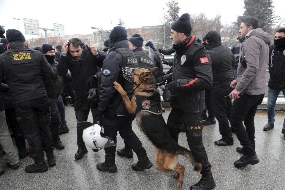 Riot police detain a lawyer as dozens of demonstrators gathered in front of Turkey's parliament to protest proposed amendments to the country's constitution that would hand sweeping executive powers to President Recep Tayyip Erdogan's largely ceremonial presidency, in Ankara, Turkey, Monday. Jan. 9, 2017. Parliament is kicking off a debate Monday on a set of draft amendments.(AP Photo/Burhan Ozbilici)