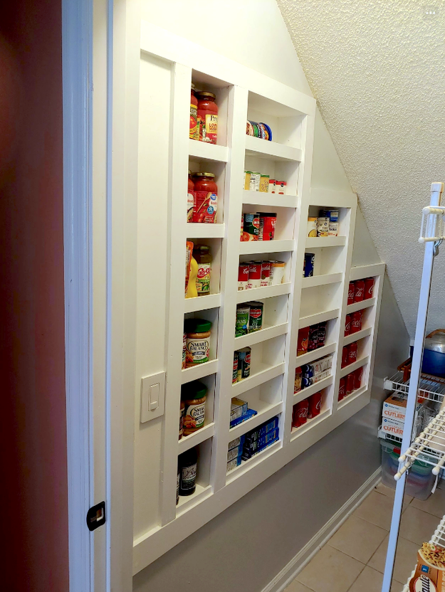 between the studs pantry in a kitchen storing various non-perishables