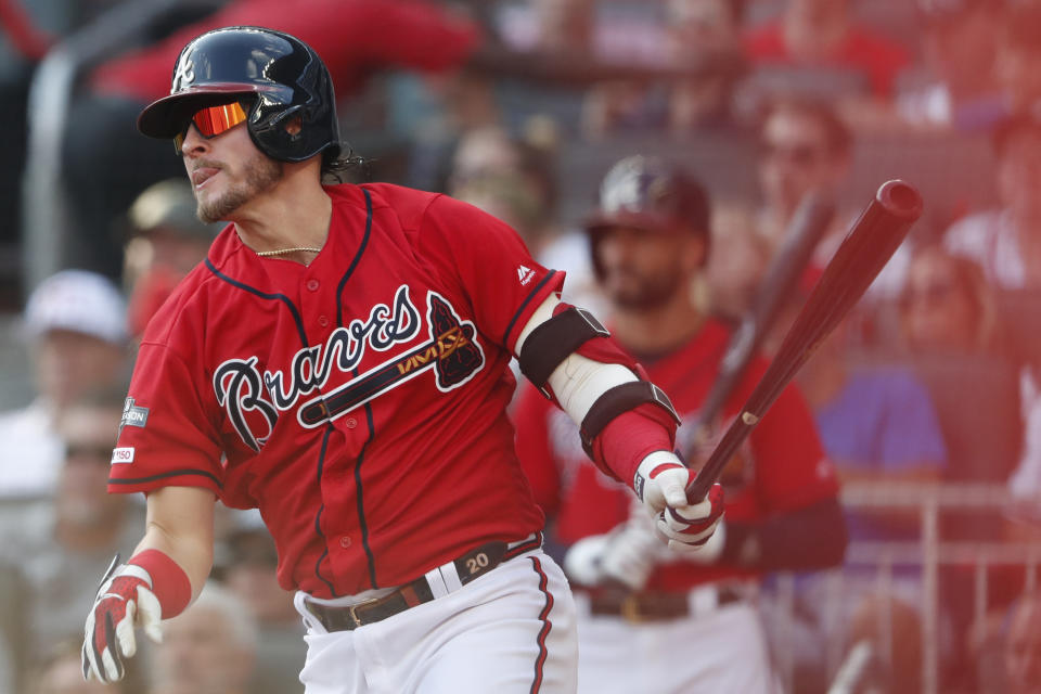 Atlanta Braves third baseman Josh Donaldson (20) follows through after hiting an RBI single against the St. Louis Cardinals in the first inning during Game 2 of a best-of-five National League Division Series, Friday, Oct. 4, 2019, in Atlanta. (AP Photo/John Bazemore)