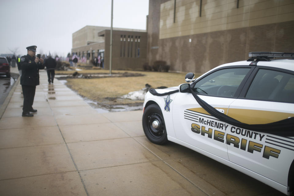 A McHenry County Sheriff's vehicle serving as a memorial car is parked outside before funeral services for slain McHenry County Sheriff's Deputy Jacob Keltner on Wednesday, March 13, 2019, at Woodstock North High School in Woodstock, Ill. Keltner was shot and killed while trying to serve an arrest warrant at a hotel on March 7, 2019. (Scott P. Yates/Rockford Register Star via AP)