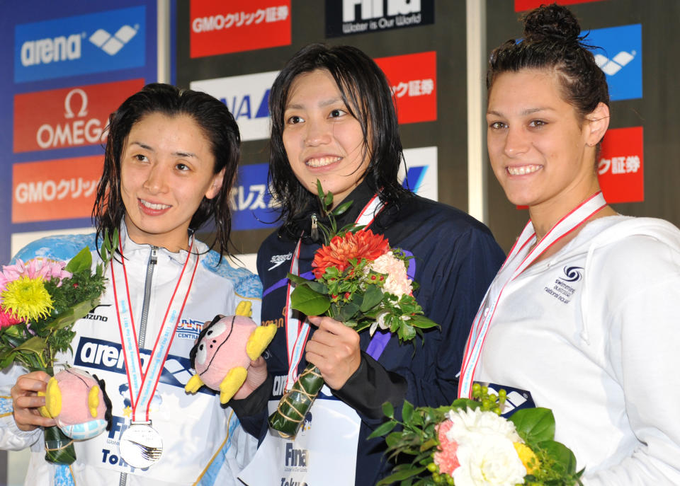 Blair Evans, right, stands with her bronze medal alongside silver medalist Hanae Ito, left, and gold medalist Haruka Ueda after the women's 200m freestyle final at the FINA Swimming World Cup short-course meet in Tokyo on Nov. 12, 2011. (KAZUHIRO NOGI/AFP/Getty Images)