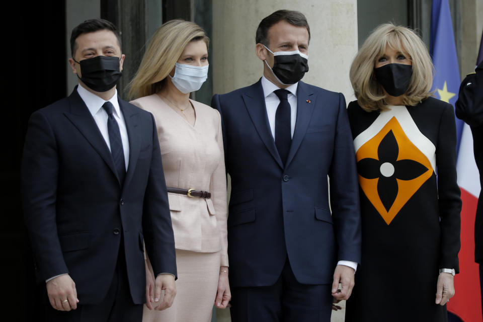 French President Emmanuel Macron, second right, and his wife Brigitte Macron, right, pose with Ukrainian President Volodymyr Zelenskyy, left, and Olena Zelenska before a working lunch at the Elysee palace in Paris, Friday, April 16, 2021. Ukrainian President Volodymyr Zelenskyy is holding talks with French President Emmanuel Macron and German Chancellor Angela Merkel amid growing tensions with Russia, which has deployed troops at the border with the country. (AP Photo/Lewis Joly)