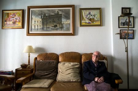 Esperanza Fernandez, 103, poses for a portrait in the living room of her home in Salamanca, central Spain, October 21, 2016. Fernandez lives with her daughters. Two of her sisters lived past 100 and another is about to celebrate her 100th birthday. She remembers when an outbreak of influenza killed nearly half of her village as a child. Her father shut the family in their house and prevented anyone from entering. REUTERS/Andrea Comas