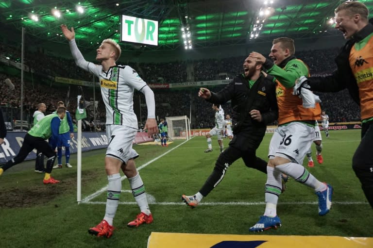 Moenchengladbach defender Oscar Wendt (L) celebrates scoring his team's third goald during the Bundesliga match against SV Darmstadt in Moenchengladbach on December 20, 2015