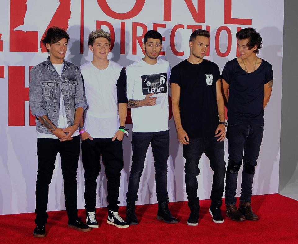 One Direction, from left to right, Louis Tomlinson, Niall Horan, Zayn Malik, Liam Payne and Harry Styles, at a photocall to promote the film, This Is Us, at the Sky Studios, London, Monday Aug. 19, 2013. The film is an intimate all-access look at life on the road for the global music phenomenon. (Photo by Jon Furniss Photography/Invision/AP)