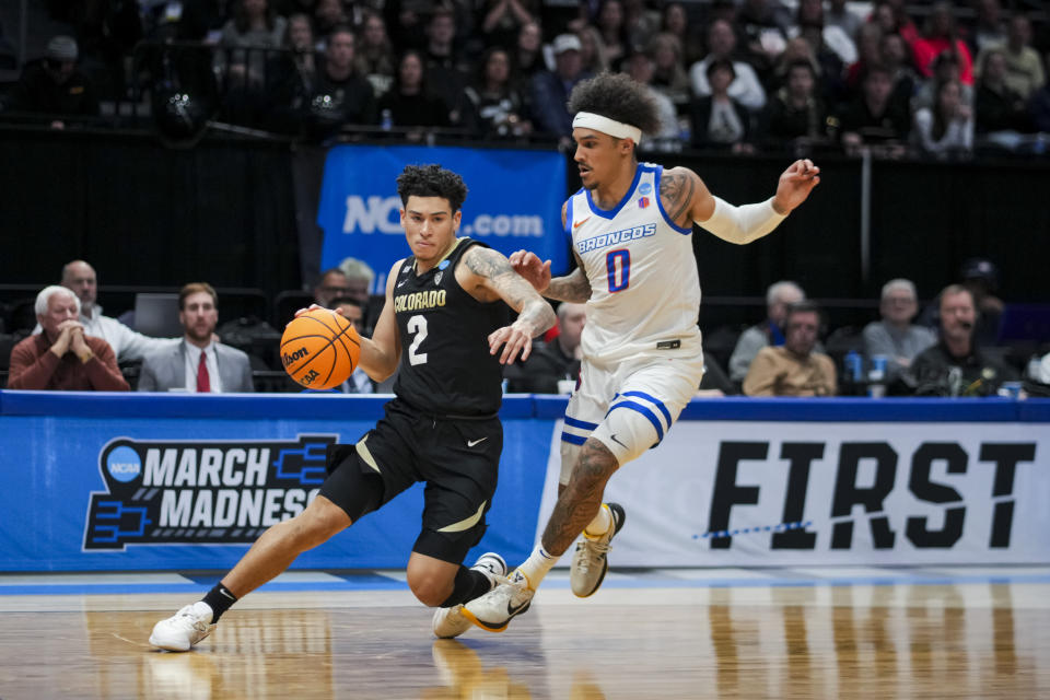Colorado guard KJ Simpson, left, drives against Boise State guard Roddie Anderson III during the second half of a First Four game in the NCAA men's college basketball tournament Wednesday, March 20, 2024, in Dayton, Ohio. (AP Photo/Aaron Doster)