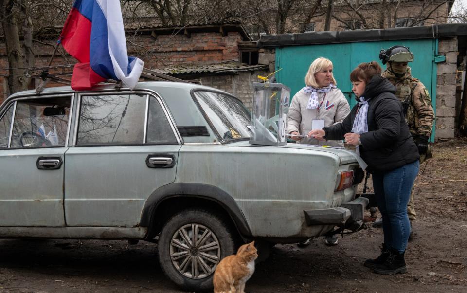 Members of a local election commission prepare a mobile polling station during early voting in Donetsk