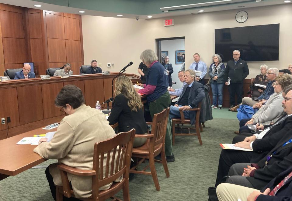 Erie County Council members, from top left, Tom Spagel, Andre Horton and Charlie Bayle listen during a regular meeting Tuesday at Erie County Courthouse's Room 117. Members of the public addressed council regarding a resolution that allows Gannon University to build a water research and education center inside Blasco Memorial Library. The resolution passed with a 5-2 vote.