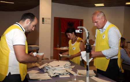 Election officials start counting the votes from the parliamentary elections in Tirana, Albania June 26, 2017. REUTERS/Florion Goga