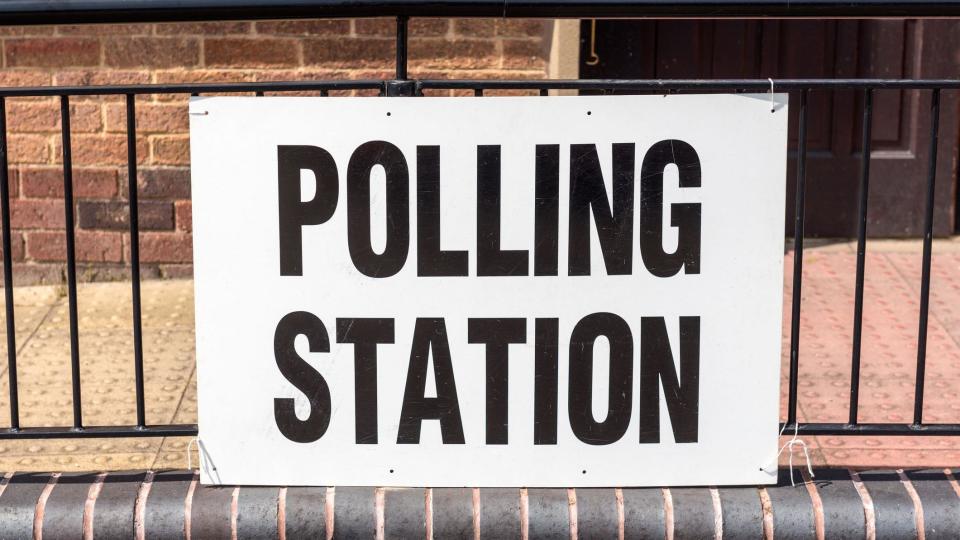 A 'Polling Station' sign outside village hall during a UK election.