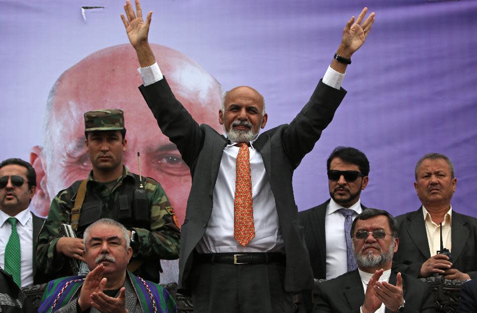 Afghan presidential candidate Ashraf Ghani Ahmadzai waves to his supporters during a campaign rally in Kabul, Afghanistan, Tuesday, April 1, 2014. Eight Afghan presidential candidates are campaigning for the third presidential election. Elections will take place on April 5, 2014. (AP Photo/Massoud Hossaini)