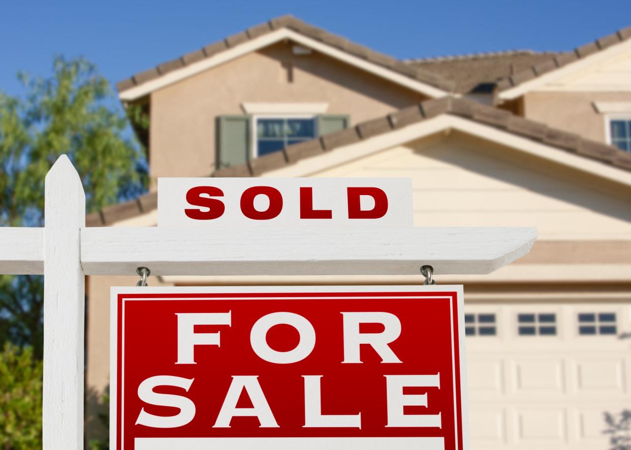 Sale signs in front of a house.