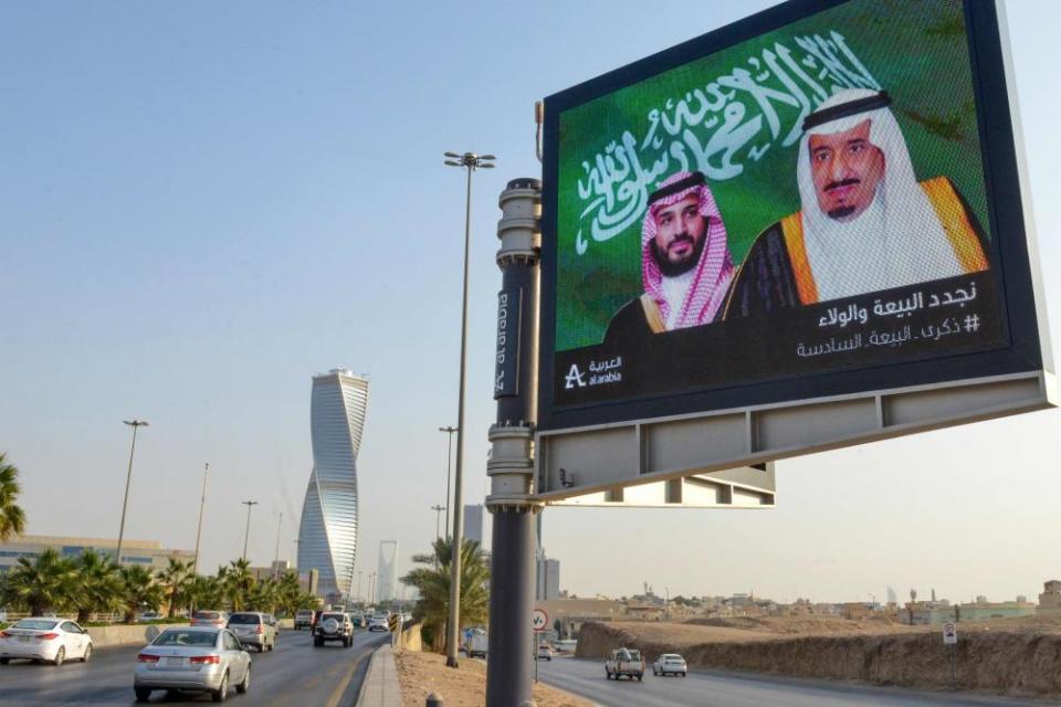 An electronic billboard bearing the portraits of the Saudi king, Salman bin Abdulaziz (right) and his son Mohammed bin Salman, ahead of a meeting of finance ministers and central bank governors of the G20 nations in the Saudi capital Riyadh.