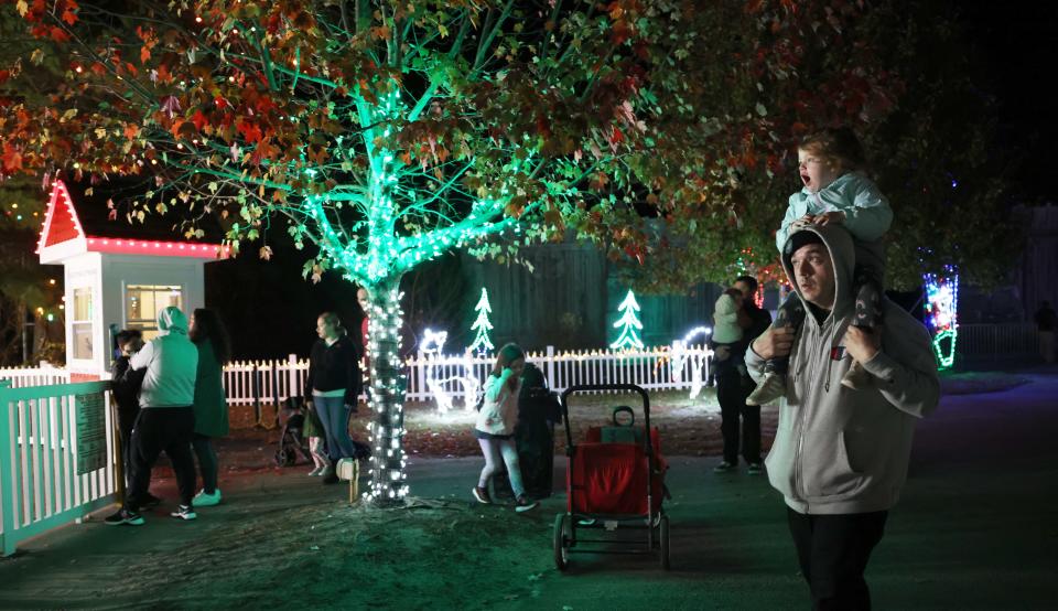 Paul Dugis of Wareham, with daughter Elizabeth Dugis, enjoy Edaville's Christmas Festival of Lights on Thursday, Nov. 10, 2022 at Edaville Family Theme Park in Carver.