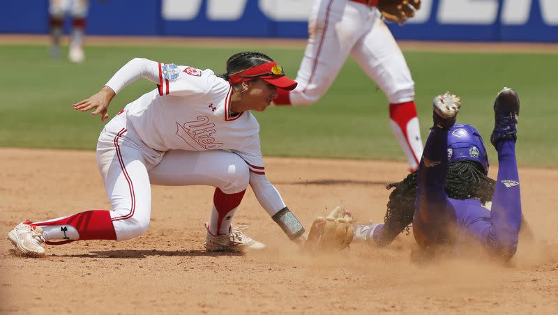 Washington’s Brooklyn Carter, right, steals second base past Utah’s Aliya Belarde in the second inning of a Women’s College World Series game Friday, June 2, 2023, in Oklahoma City. The Utes face Oklahoma State in an elimination game Friday night.