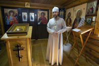 Russian Orthodox priest father Vladimir stands inside a church at the Russian naval facility in Tartus, Syria, on patrol in eastern Mediterranean, Thursday, Sept. 26, 2019. Russia has a naval base in Tartus, the only such facility it has outside the former Soviet Union. (AP Photo/Alexander Zemlianichenko)