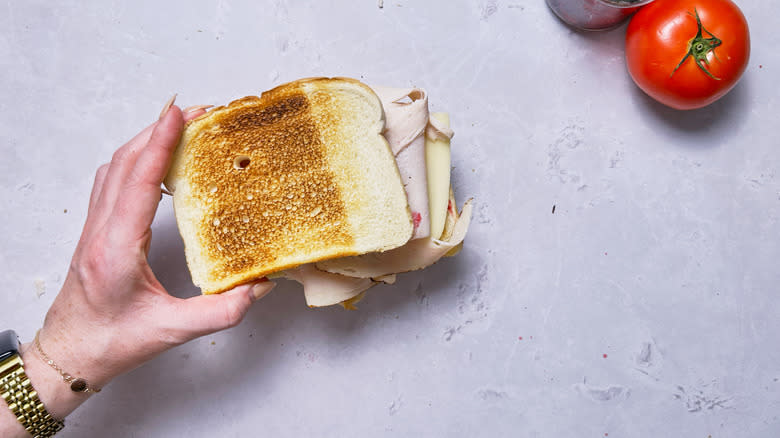 adding bread to sandwich