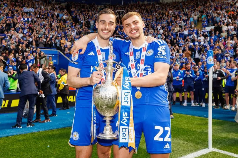 Harry Winks and Kiernan Dewsbury-Hall celebrate Leicester City's title success with the Championship trophy