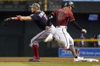 Washington Nationals first baseman Ryan Zimmerman, left, makes a catch in time to get Arizona Diamondbacks' Tim Locastro, right, out at first base during the second inning of a baseball game Sunday, May 16, 2021, in Phoenix. (AP Photo/Ross D. Franklin)