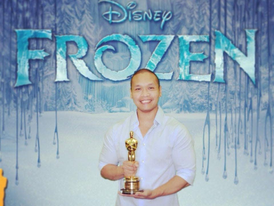 Bobby Pontillas holding an Oscar for Frozen