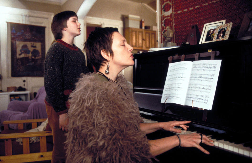 closeup of the two at a piano