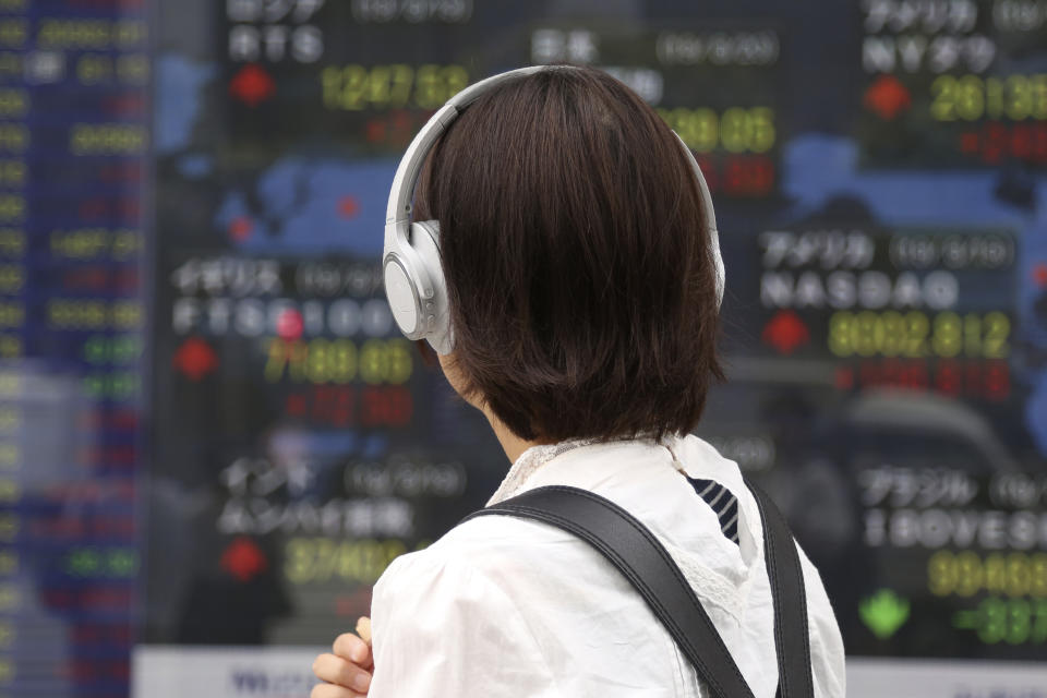 A woman looks at an electronic stock board of a securities firm in Tokyo, Tuesday, Aug. 20, 2019. Asian shares were mostly higher Tuesday after Wall Street rallied on the U.S. decision to give Chinese telecom giant Huawei another 90 days to buy equipment from American suppliers. (AP Photo/Koji Sasahara)