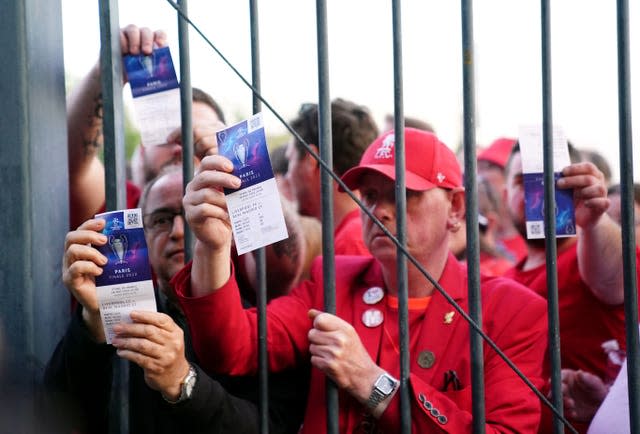 Liverpool fans stuck outside the ground show their match tickets during the UEFA Champions League Final at the Stade de France, Paris. Picture date: Saturday May 28, 2022.