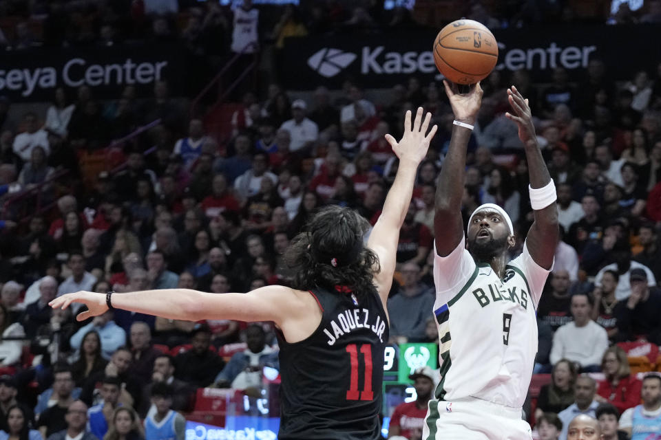 Milwaukee Bucks forward Bobby Portis (9) takes a shot against Miami Heat forward Jaime Jaquez Jr. (11) during the first half of an NBA basketball game, Tuesday, Nov. 28, 2023, in Miami. (AP Photo/Wilfredo Lee)