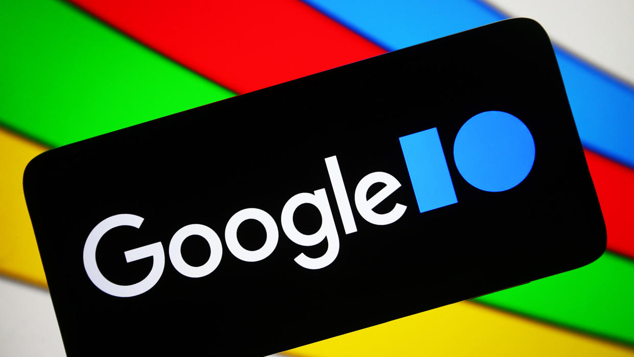  The Google I/O logo on a black smartphone against a colorful background using the Google colors 