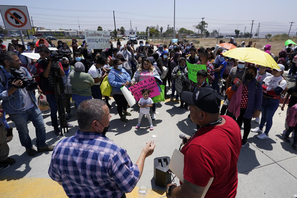 FILE - People gather as Rev. Albert Rivera, bottom left, speaks during a protest of people waiting in Mexico as they hope to apply for asylum, May 19, 2022, in Tijuana, Mexico. The Supreme Court has ruled that the Biden administration properly ended a Trump-era policy forcing some U.S. asylum-seekers to wait in Mexico. The justices’ 5-4 decision for the administration came in a case about the “Remain in Mexico” policy under President Donald Trump. (AP Photo/Gregory Bull, File)