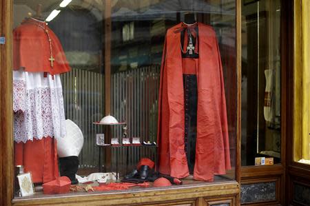 Cardinals vestments are seen on display at the window of the Gammarelli tailor shop in Rome February 11, 2014. REUTERS/Max Rossi