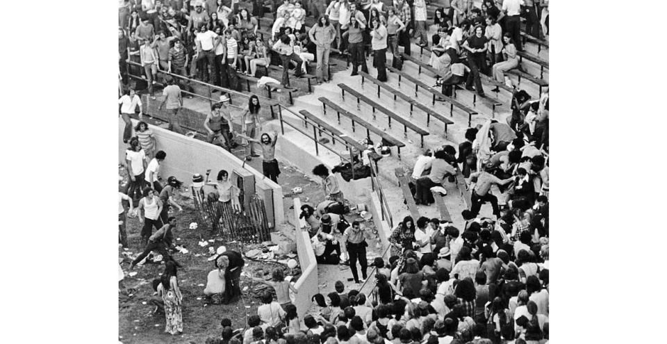 Some concertgoers try to keep the peace while others hurl objects at Akron police during the Rolling Stones concert July 11, 1972, at the Rubber Bowl.