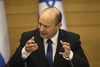 Israel's new prime minister Naftali Bennett holds a first cabinet meeting in Jerusalem Sunday, June 13, 2021. Israel's parliament has voted in favor of a new coalition government, formally ending Prime Minister Benjamin Netanyahu's historic 12-year rule. Naftali Bennett, a former ally of Netanyahu became the new prime minister (AP Photo/Ariel Schalit)