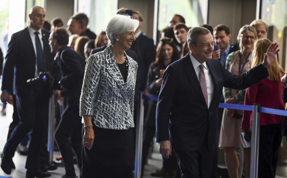 European Central Bank president Christine Lagarde, left, walks with former ECB president Mario Draghi during a ceremony to celebrate the 25th anniversary of the ECB, in Frankfurt, Germany, Wednesday May 24, 2023. (Kai Pfaffenbach/Pool via AP)