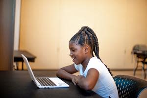 A student works one-on-one with a volunteer literacy tutor using the new Reading Partners Connects platform (Photo credit: Reading Partners)